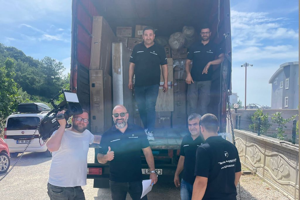 a group of men standing in the back of a truck